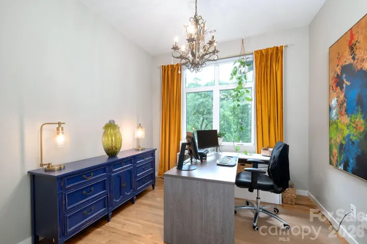 Dedicated office with large window views, warm natural light, and space for working from home.