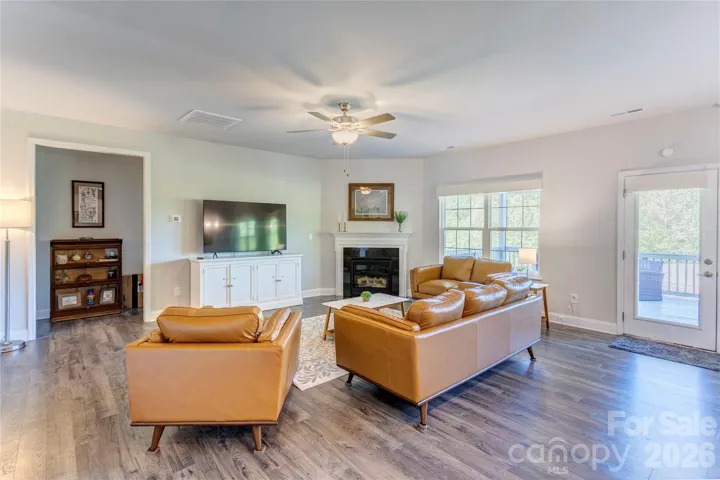 Cozy sitting area in the family room looks onto covered deck and at golf course