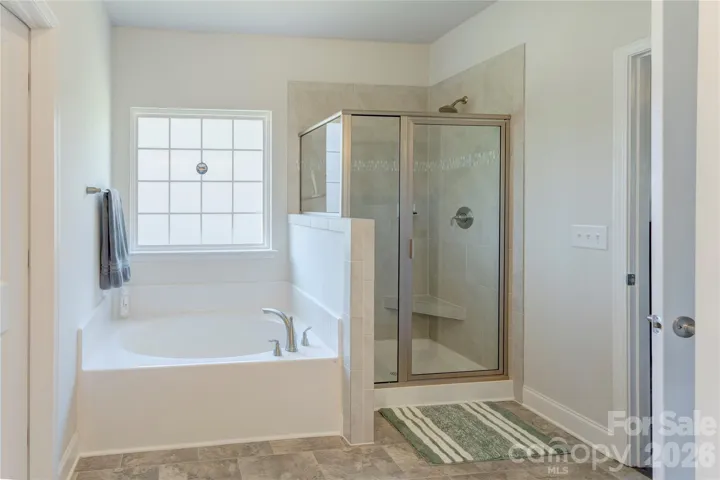 Primary bath features a soaking tub and separate shower
