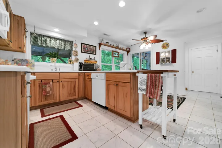 The kitchen and breakfast nook are a large area together and give a great spot for preparation of meals. Lots of windows.