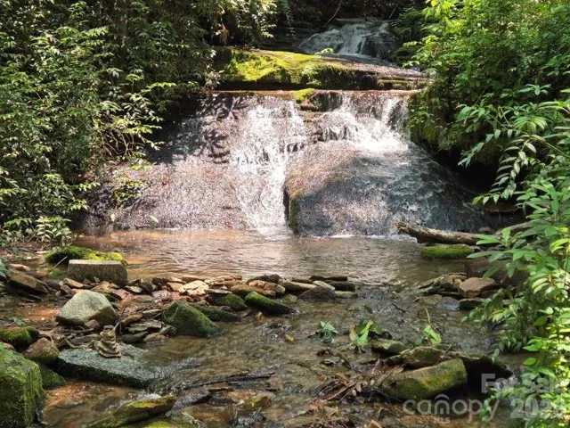 This waterfall is at a neighbors house, called "The Waterfall House", just downstream from where your creek leaves your property.