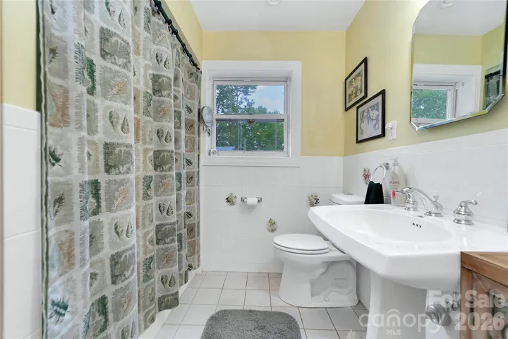 On the garage side of the house there is another full bath. It is nestled within the three additional bedrooms.