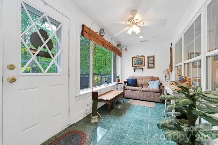 The sunroom is just in from the front deck, very sunny and bright, a wonderful place to sit and read or converse.