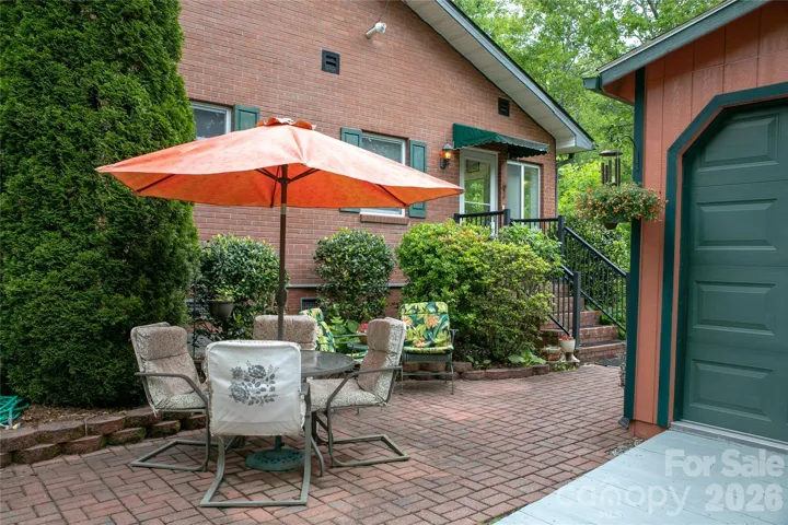When not out front in the sitting garden, front porch or sunroom; you can relax outside the side door on the brick patio near the garage.The foyer / entry leads you from the sunroom to the living room with a beautiful wooden floor.