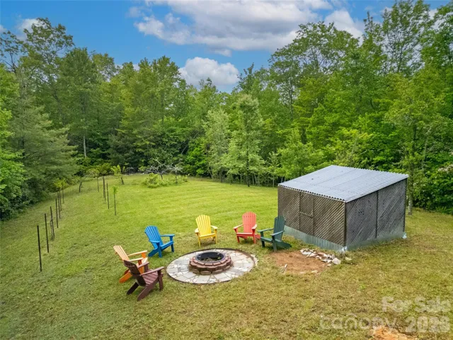 This knoll is just across the spring run from the house. The fire pit is a wonderful spot to watch the Indian Camp Mountain stars at night. This is a large open meadow, pear trees at the end, an old vineyard on the left side, and a great shed as well.
