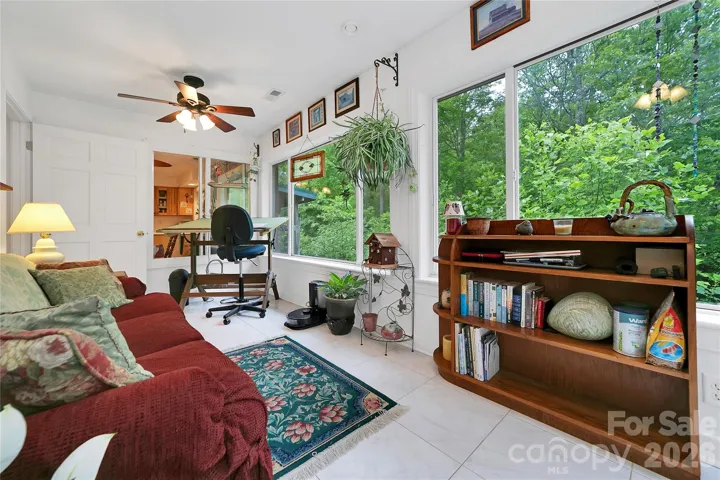 On the back side of the house towards the side door to the garage is the second / rear sunroom. Huge windows make this room a great place to relax and enjoy a book, or can be a place to work, on anything you desire.