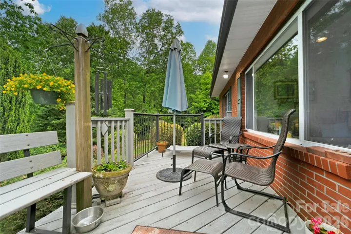 Front deck / porch looks out to your trees and shrubs, flowers and side yard.