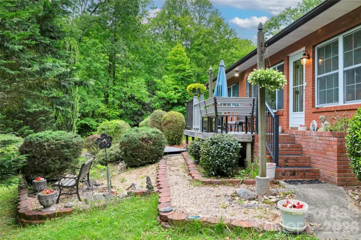 Stone path walks you through the sitting garden area over the bridge and out to the side yard. Side yard could be a great garden area.!