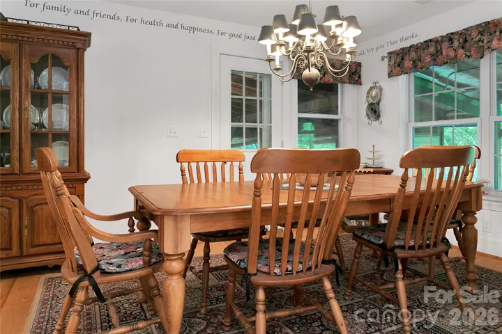 The dining room is just off of the kitchen, and leads out to the screen porch beyond.