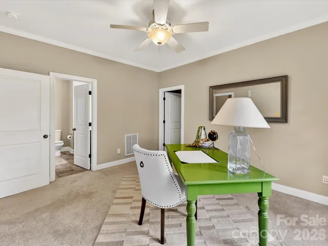 Versatile secondary bedroom or flex space featuring abundant natural light, neutral finishes, and plenty of room for a home office or guest retreat.