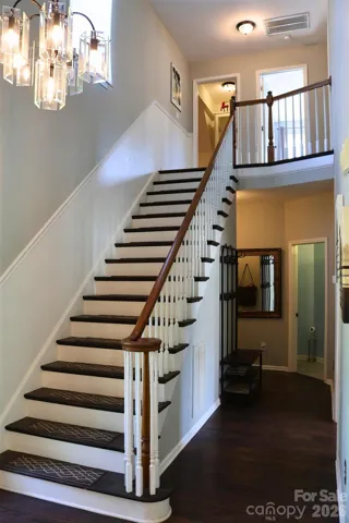 Entry Hall leading upstairs, to the laundry room, half bath and garage.
