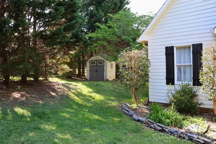 Left Side View with Shed and stone edged front landscaping enhancement