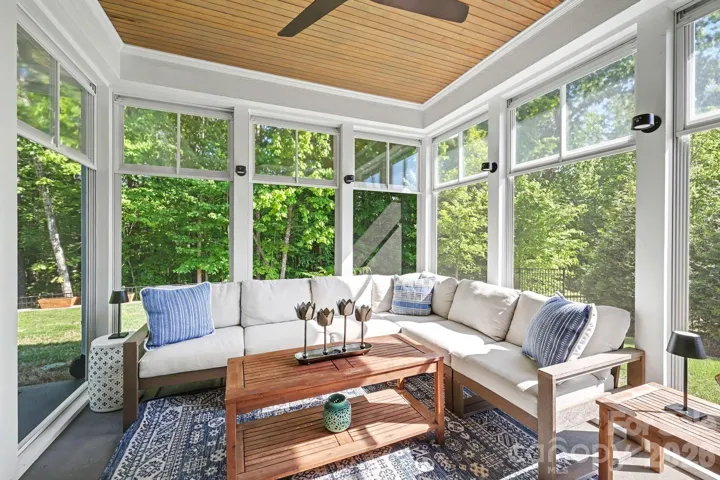 lLight filled porch enhanced with Eze Breeze windows off of the breakfast nook/kitchen