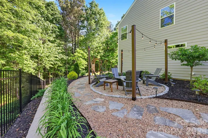 Beaautifullylandscape yard with custom stone work and fire pit