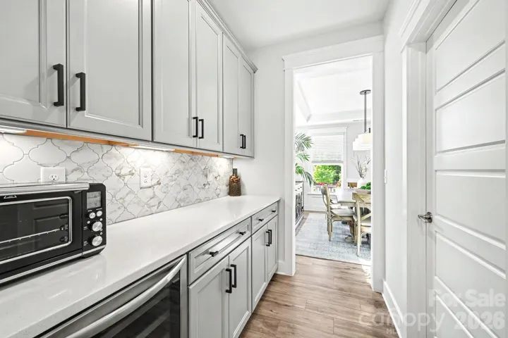 Butlers pantry area with beverage refrigerator, walk in pantry and great storage