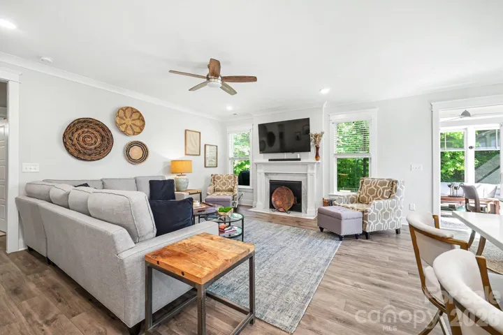 Spacious family room with gas fireplace open to the kitchen and to the back of the home