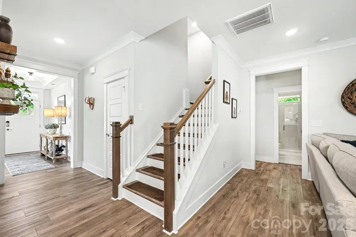 View to second floor, primary suite and garage entry