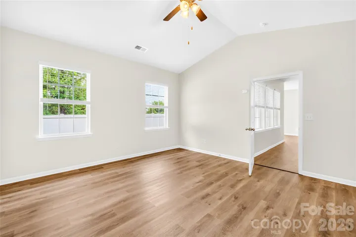 Primary bedroom has ceiling fan with lights