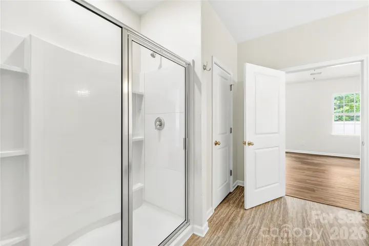 Primary oversized shower and linen closet