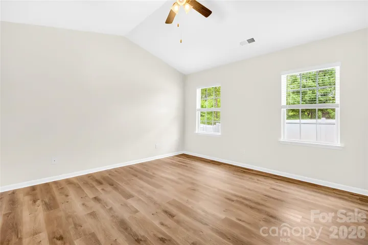 Primary bedroom has vaullted ceiling