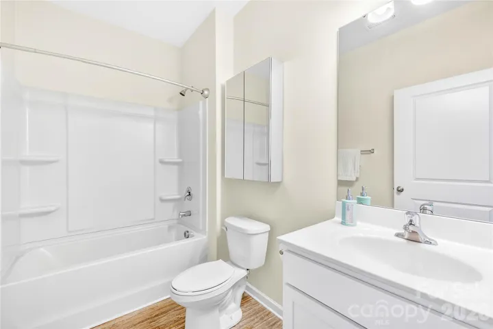 Full hall bath with added mirrored cabinet