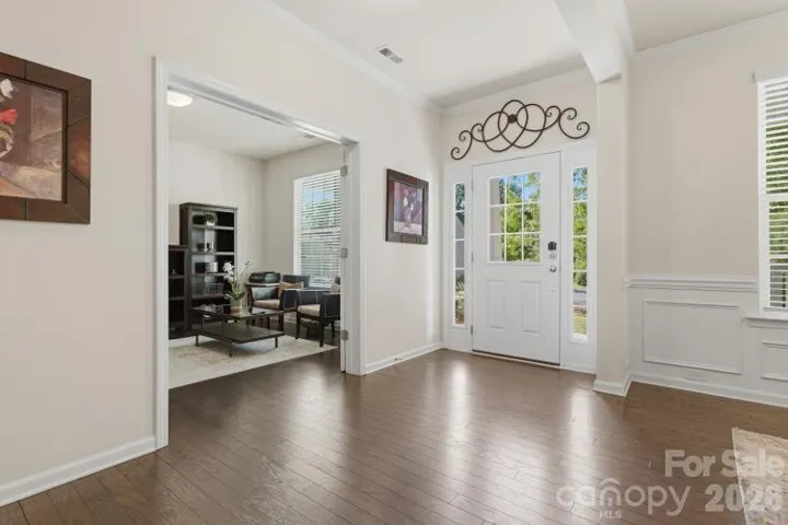 Bright and welcoming foyer featuring a beautiful front door and elegant entryway