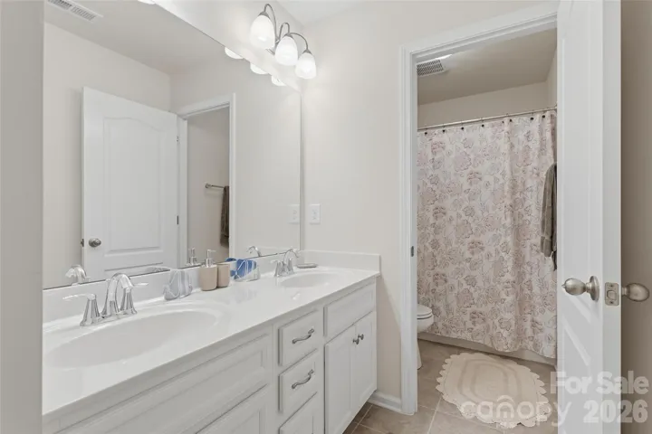Hall bathroom with double vanity 