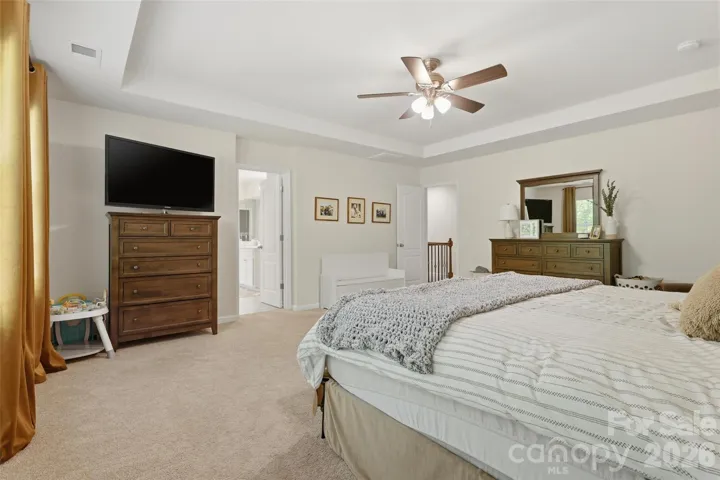 Primary bedroom with view into large ensuite bathroom