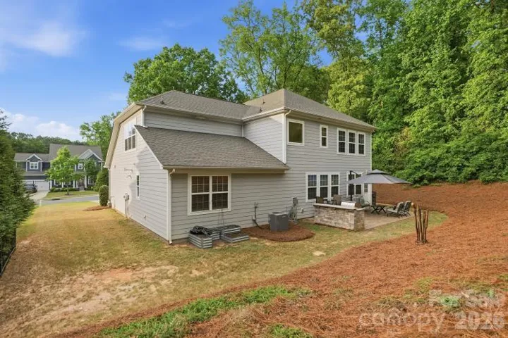 Backyard featuring paver patio and mature trees