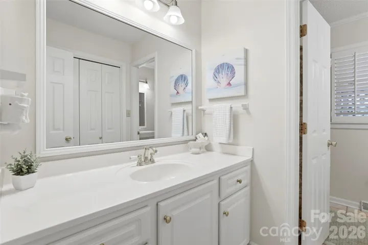 Vanity serving common bath off hallway allows for separation from the toilet and shower area with additional sink