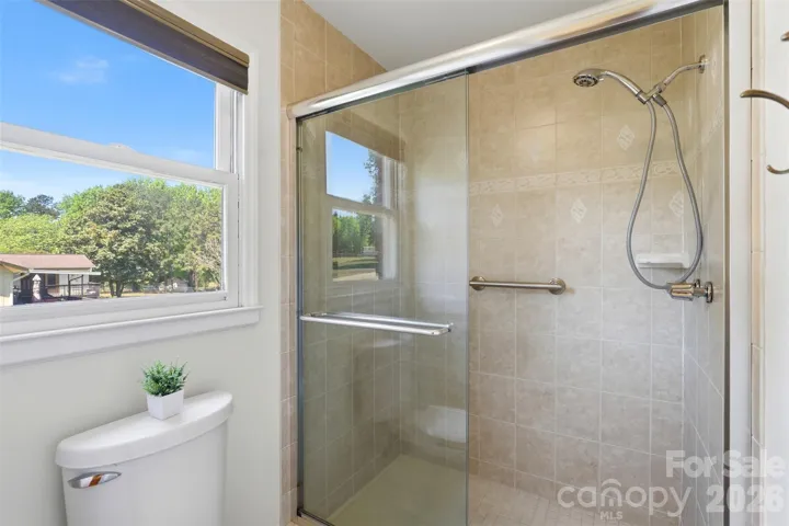 Updated shower with glass door in primary bath