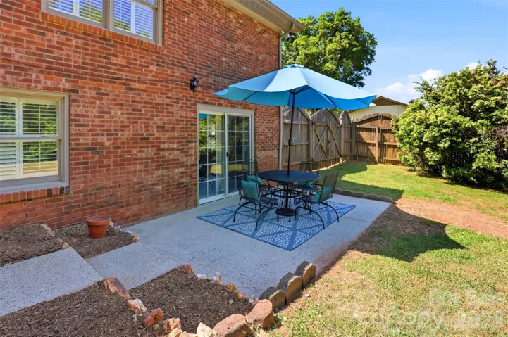 Large patio area located off the lower level with a terraced rear garden