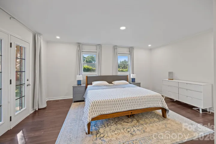 Light-filled primary bedroom with access to rear deck. 