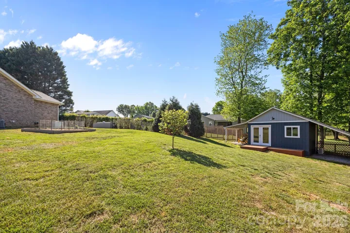 0.68 acre pie-shaped lot - side view of renovated shed and garden beds. 
