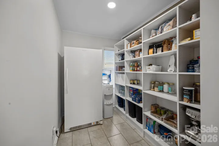 Pantry and full-size freezer (conveys) between kitchen and garage.