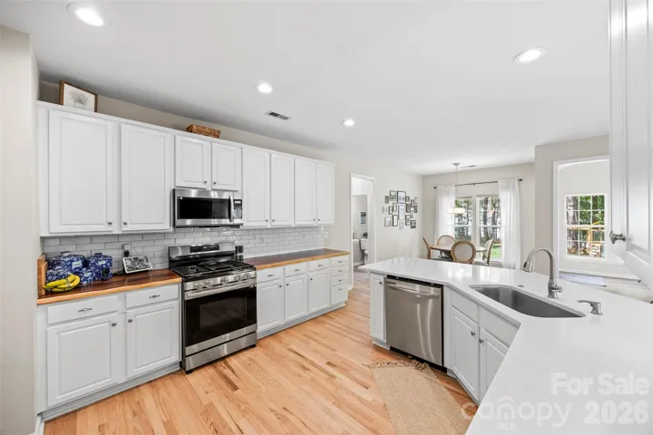 Modern kitchen featuring quartz and live edge Acacia
