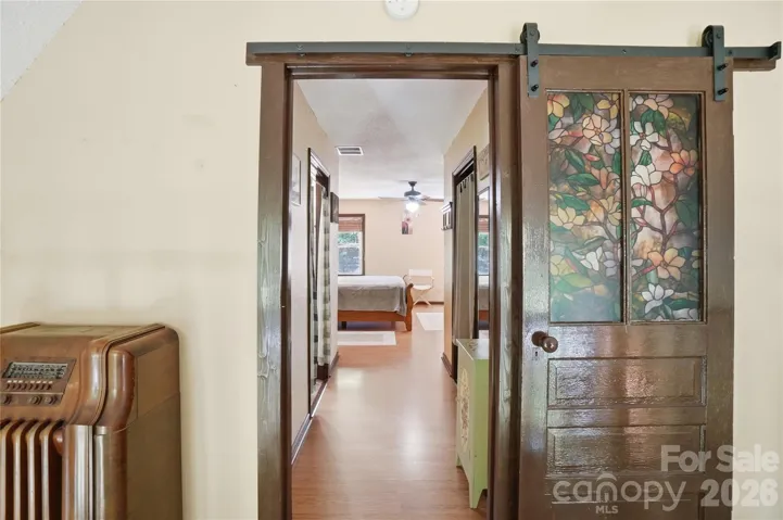 Barn door access to the primary bedroom suite