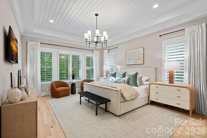 Primary suite has designer touches and access to screened porch.  