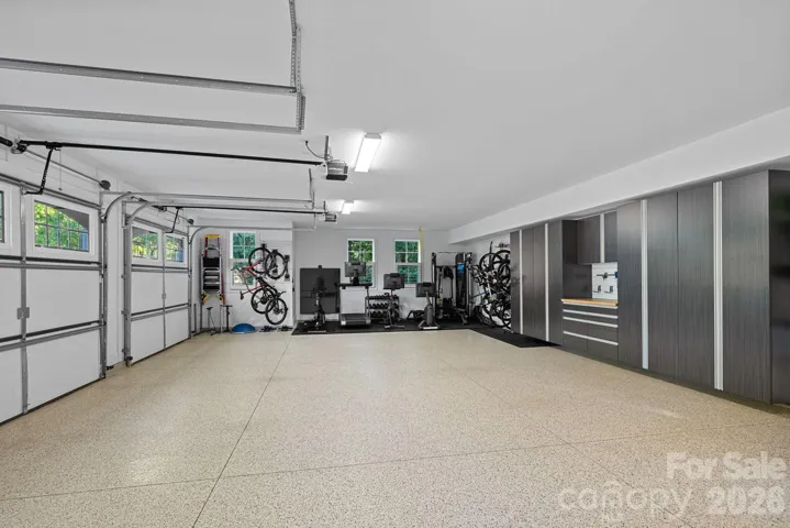 Oversized 3 car garage with room for a gym, custom cabinets and EV chargers.