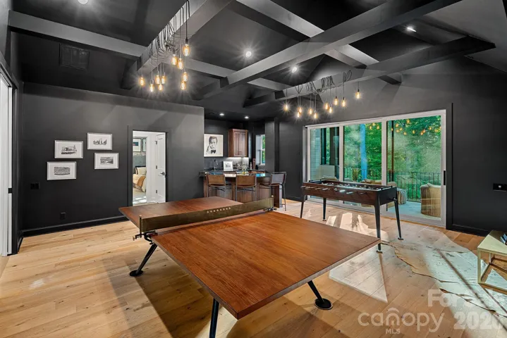 Upper level entertaining space/ game room with access to a screened porch