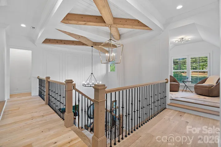 Upstairs landing features custom woodwork on the ceiling