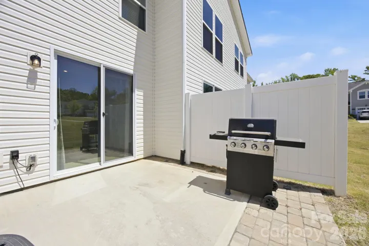 Vinyl privacy screens on both sides of the patio