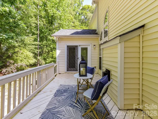 Private back deck overlooking wooded surroundings, perfect for relaxing or entertaining in a peaceful outdoor setting.
