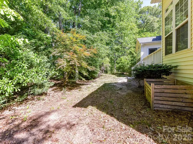 Private, wooded backyard offers a serene natural setting with plenty of space to relax or enjoy outdoor activities.