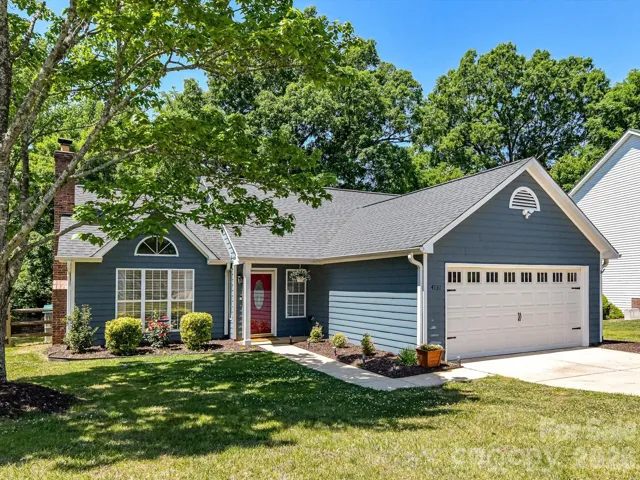 Charming single-story home with inviting curb appeal, featuring a welcoming front entry, manicured landscaping, and a two-car garage.