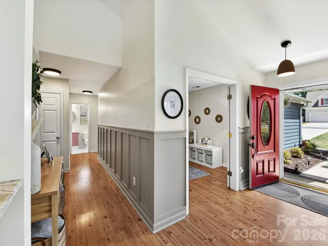 Light-filled hallway features  stylish accent trim, and a welcoming flow connecting the main living spaces and bedrooms.