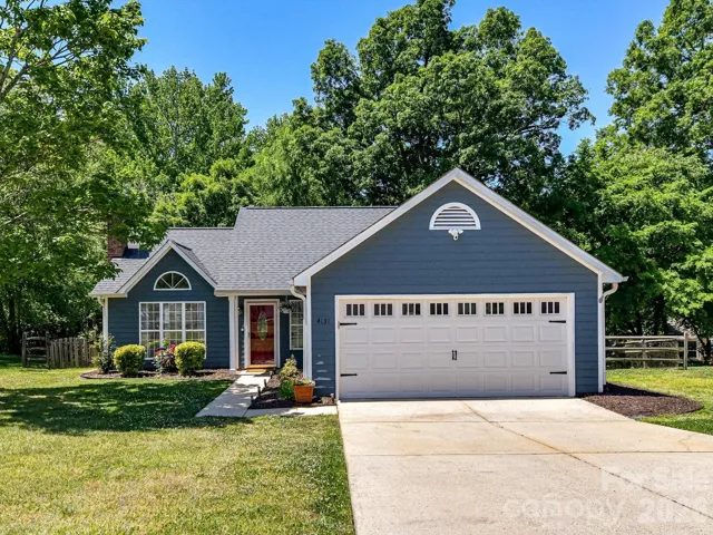 Charming single-story home with inviting curb appeal, featuring a welcoming front entry, manicured landscaping, and a two-car garage.