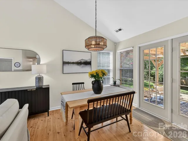 Bright dining area features vaulted ceilings and an open view to the great room with cozy fireplace.