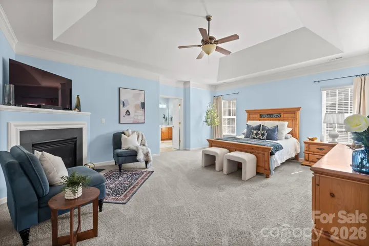 Primary suite featuring fireplace, 2 closets and bath with french doors