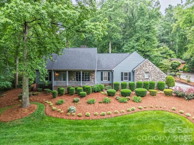 Beautiful stone and wood exterior home on a lush lot.
